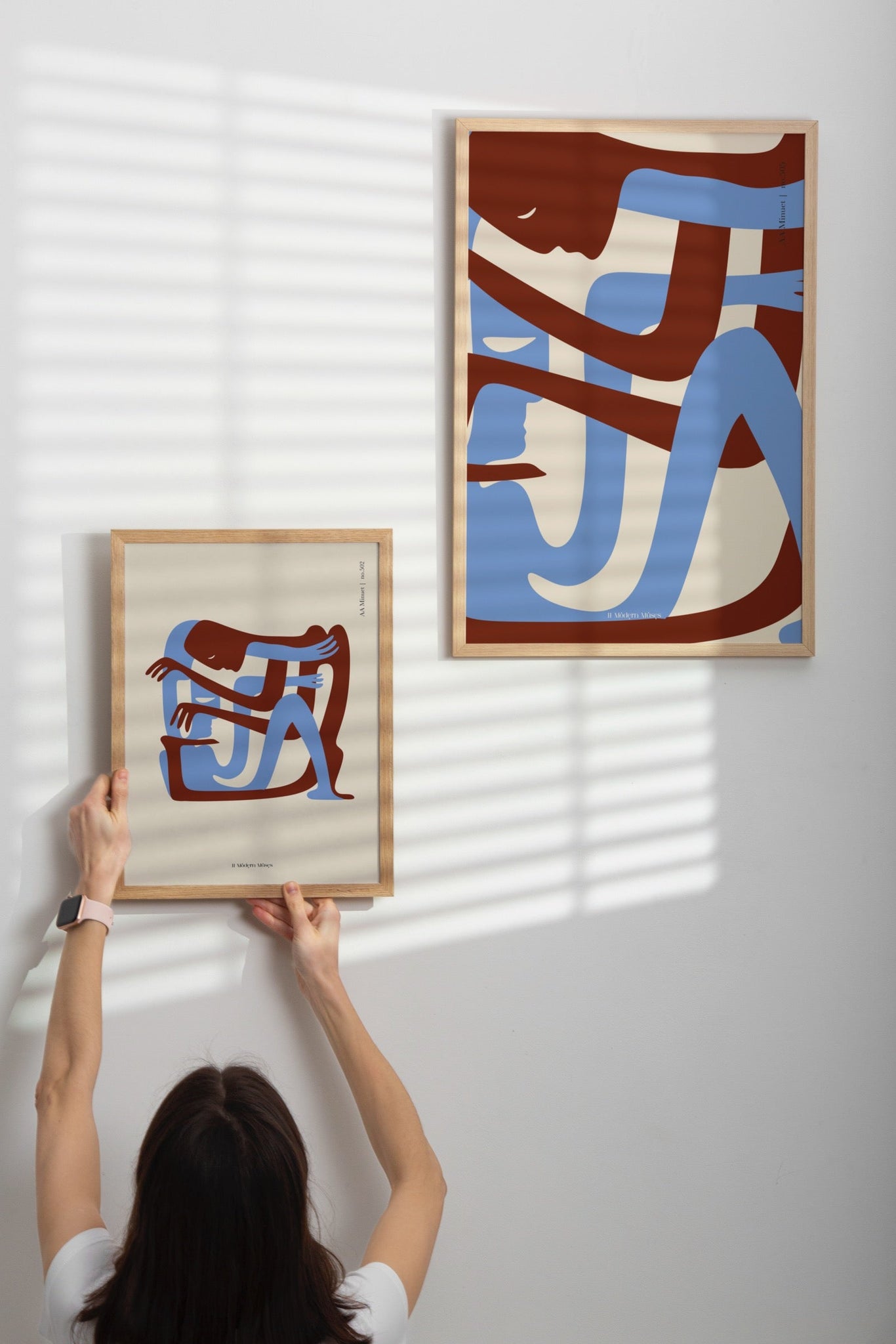 women hang frames from A_Minuet collection from local Greek Artist 11 Modern Muses